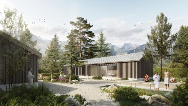 Blick in den Saunagarten mit Bergpanorama und Saunahütten